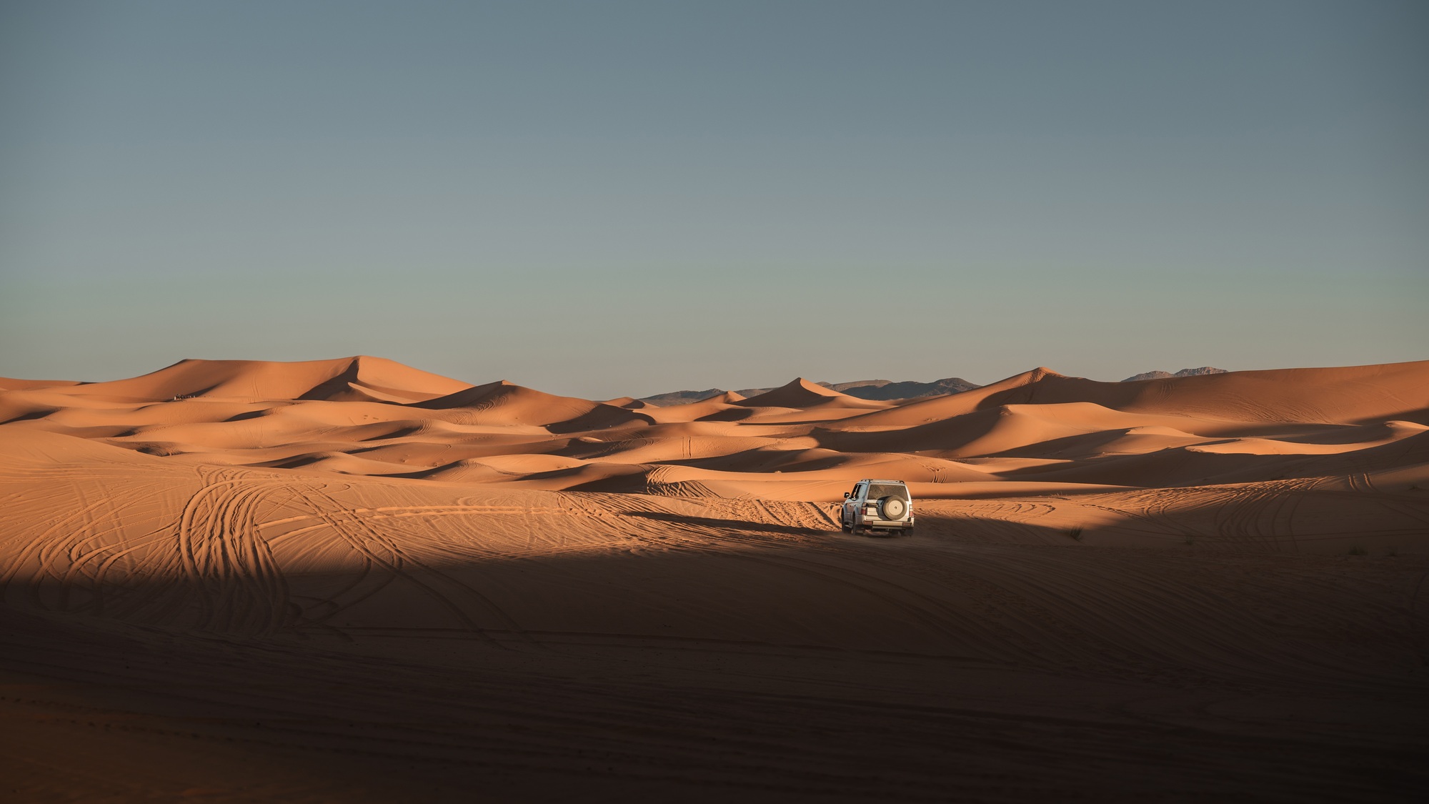 Off road vehicle exploring the majestic erg chebbi dunes in merzouga desert, morocco